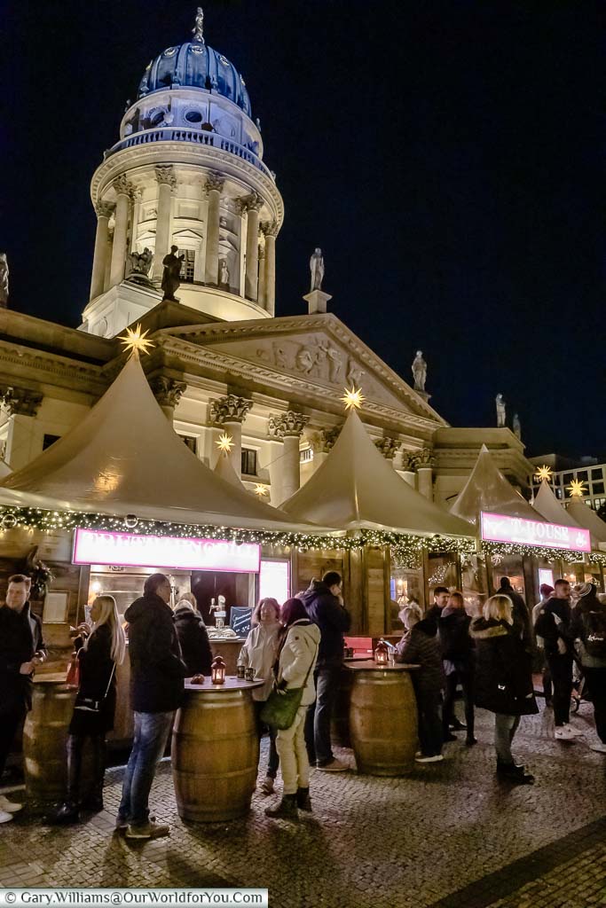 Christmas Market stalls at night at the Gendarmenmarkt in front of the Deutscher Dom, Berlin