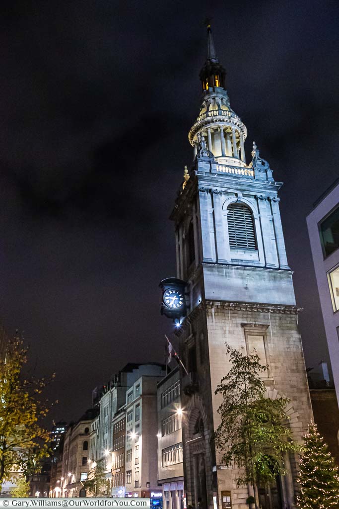 The bell tower of St Mary-le-Bow, home of Bow Bells, after sundown, lit up for London at Christmas