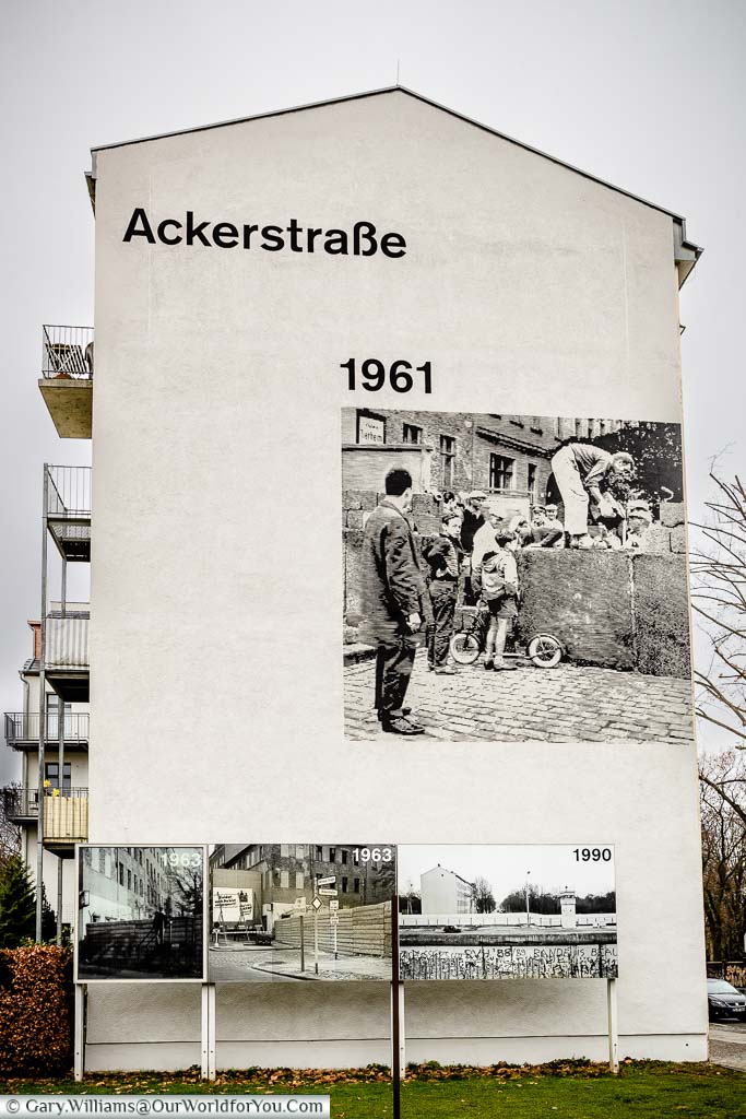The end of an apartment block with images depicting the story of the rise, and fall, of the Berlin Wall