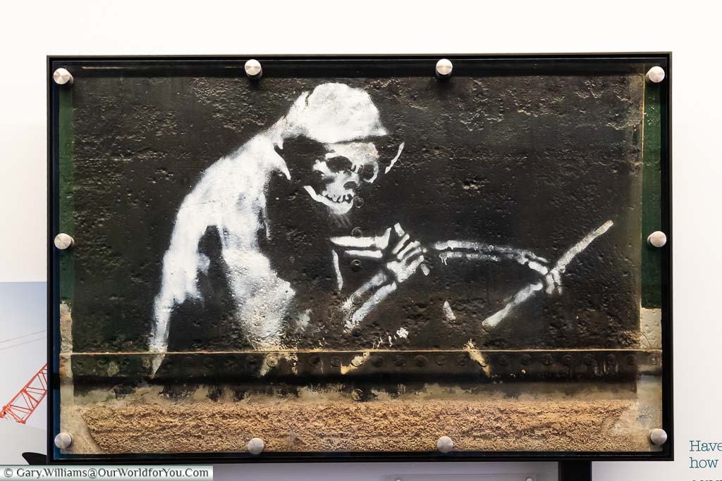 The stencilled artwork 'The Grim Reaper', now on display in M-Shed museum in Bristol