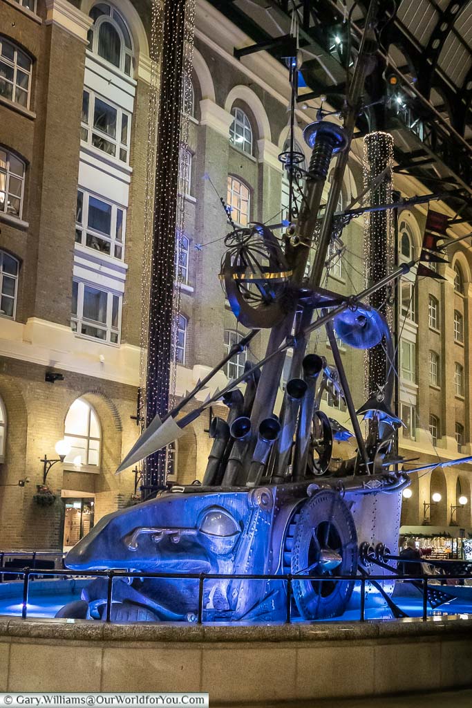 The Navigators Steampunk Statue in Hayes Galleria illuminated for Christmas in London