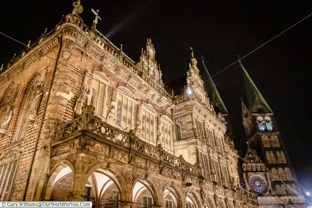 Looking up at the illuminated Rathaus, with Bremen Dom in the background after dark.