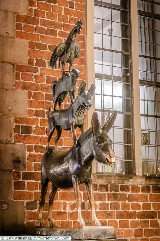 A bronze statue of a rooster, on a cat, on a dog, on a donkey representing the Town Musicians of Bremen.