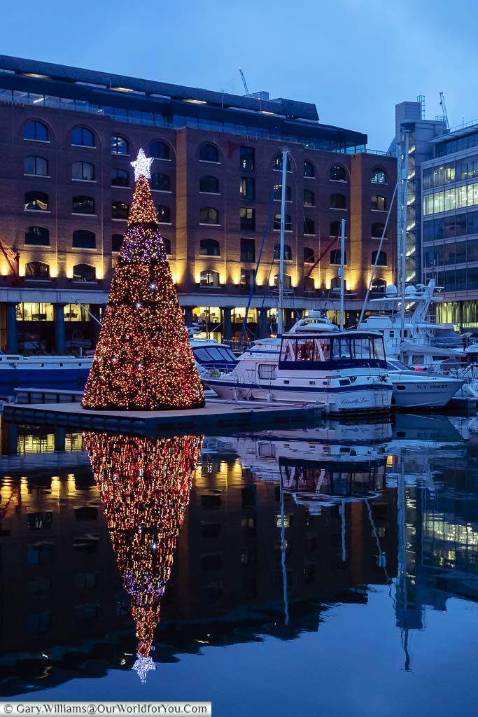 A Christmas Tree of lights on a pontoon in St Katharine Docks in London
