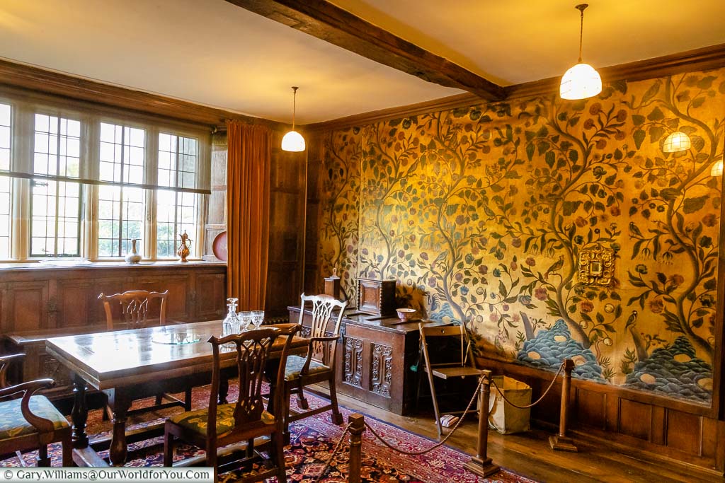 The ornate wall coverings in the dining room of Bateman's, East Sussex