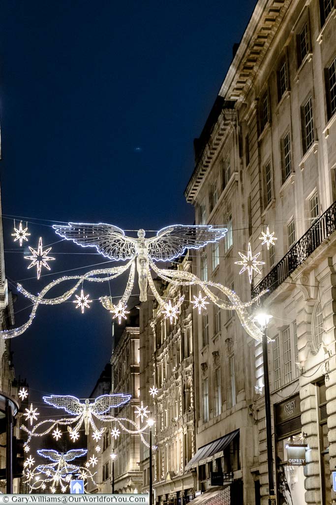 Floating illuminated angels hanging over Jermyn Street in the West End of London at Christmas