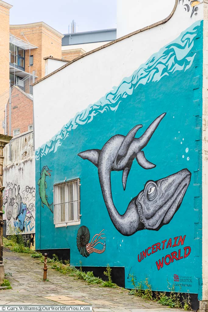 A mural of a freakish sea creature on the side of a building in Bristol