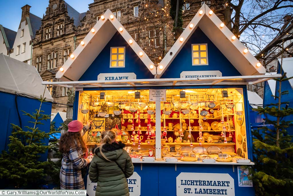 Two young ladies looking over a selection of Ceramic gifts at the St. Lamberti Christmas Market in Münster, Germany