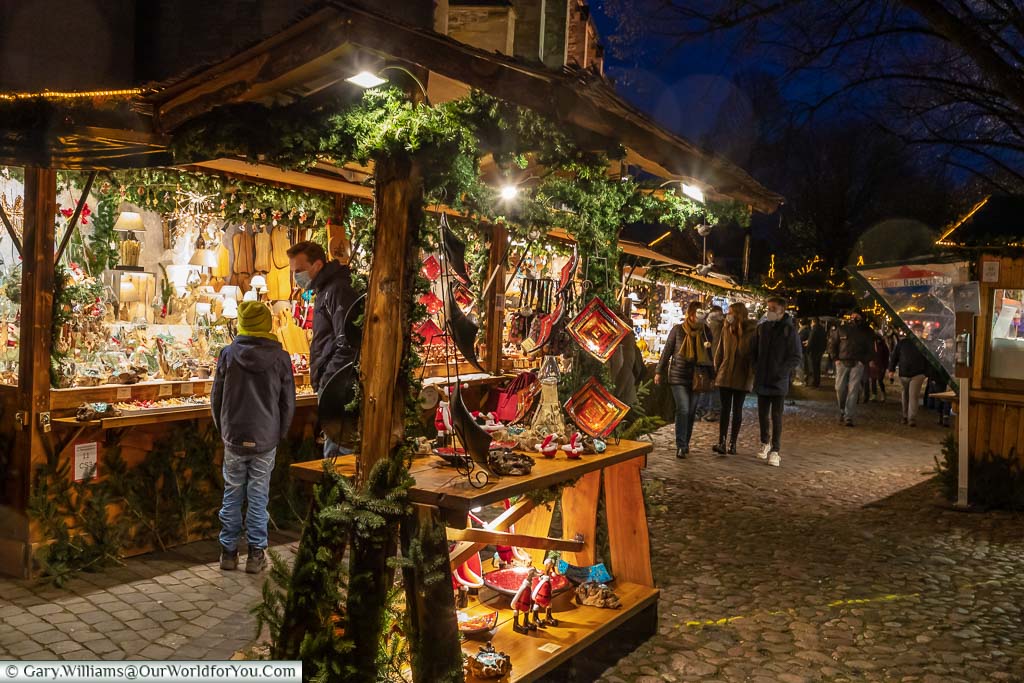 A father and son selecting a gift from a stall on the Giebelhüüskesmarkt German Christmas Market in Münster, Germany