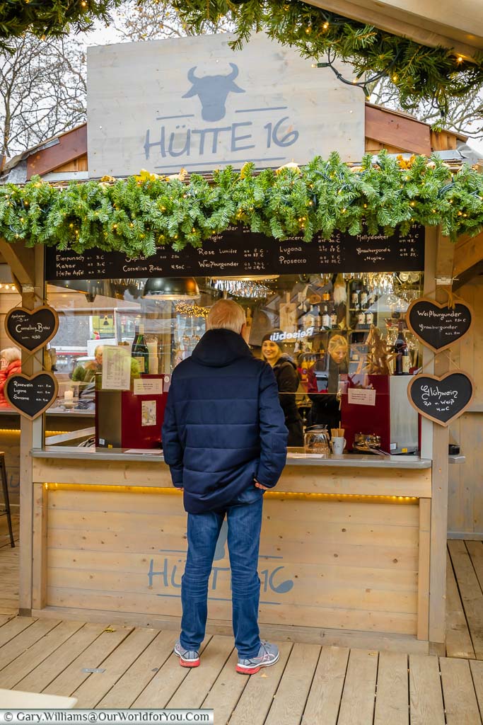 A man buying a glühwein at “Hütte 16” on the end of Aachen Christmas Markets.