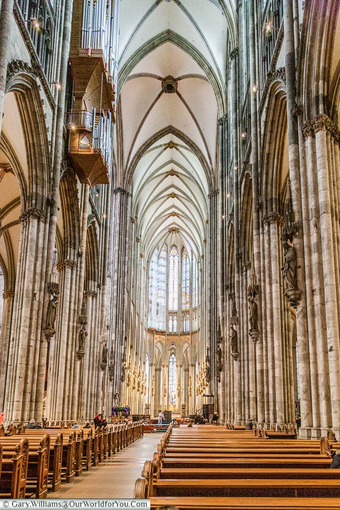 The isle of Cologne's cathedral with its stone pillars and high vaulted ceiling