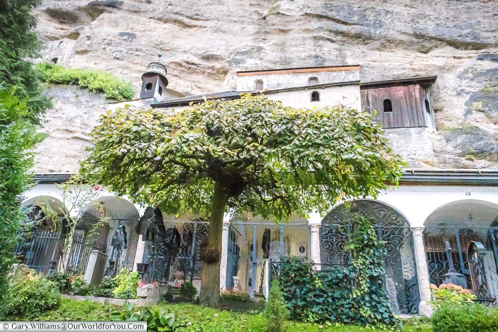 Family crypts below the rockface in the St Sebastian's Cemetery in Salzburg, Austria