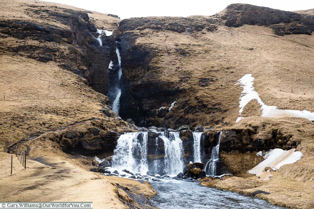 Watching the water drop its entire length in the Gluggafoss waterfall in Iceland