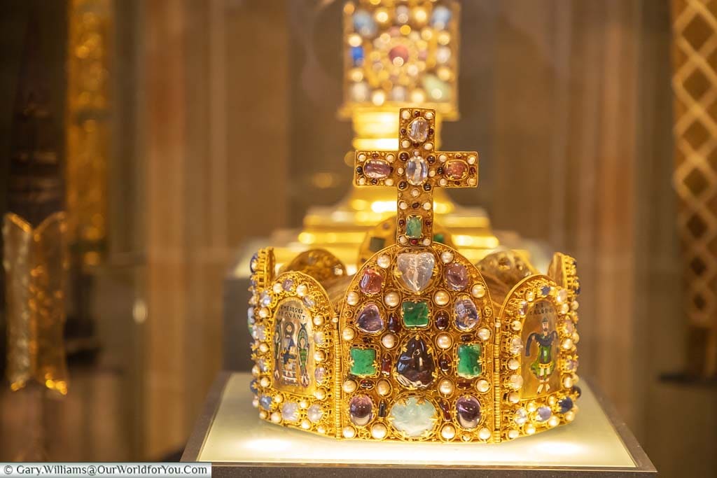 A close up of the ornate Imperial Crown in a glass cabinet in Aachen's Coronation Hall in the Rathaus
