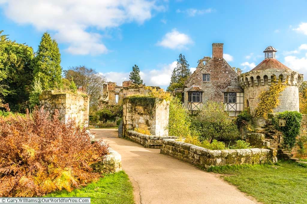 The path leading through the ruins of the outer walls of Scotney Castle on a bright autumnal day