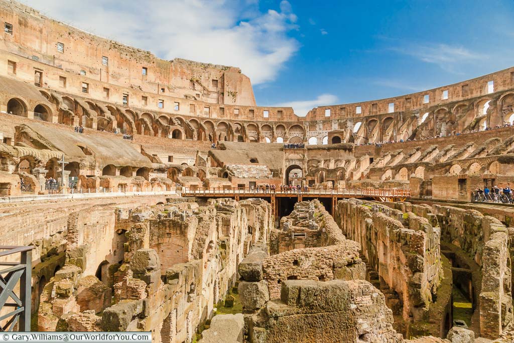 Inside the Colosseum, in Rome, at the arena level overlooking the exposed underfloor area.