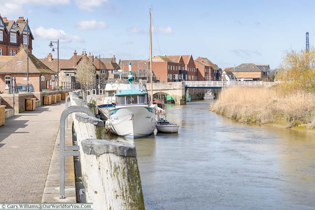 Small boats moored up on the quayside of the River Stour in Sandwich, Kent