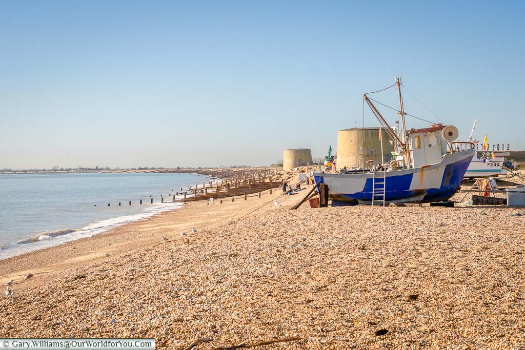 Fishing boats on the beach at Hythe with the Martello Towers in the background