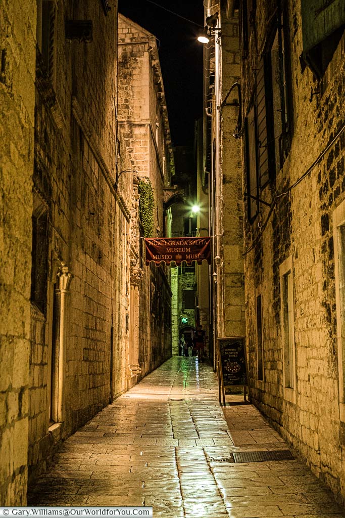 A stone path down an alleyway in Split, Croatia, after dark