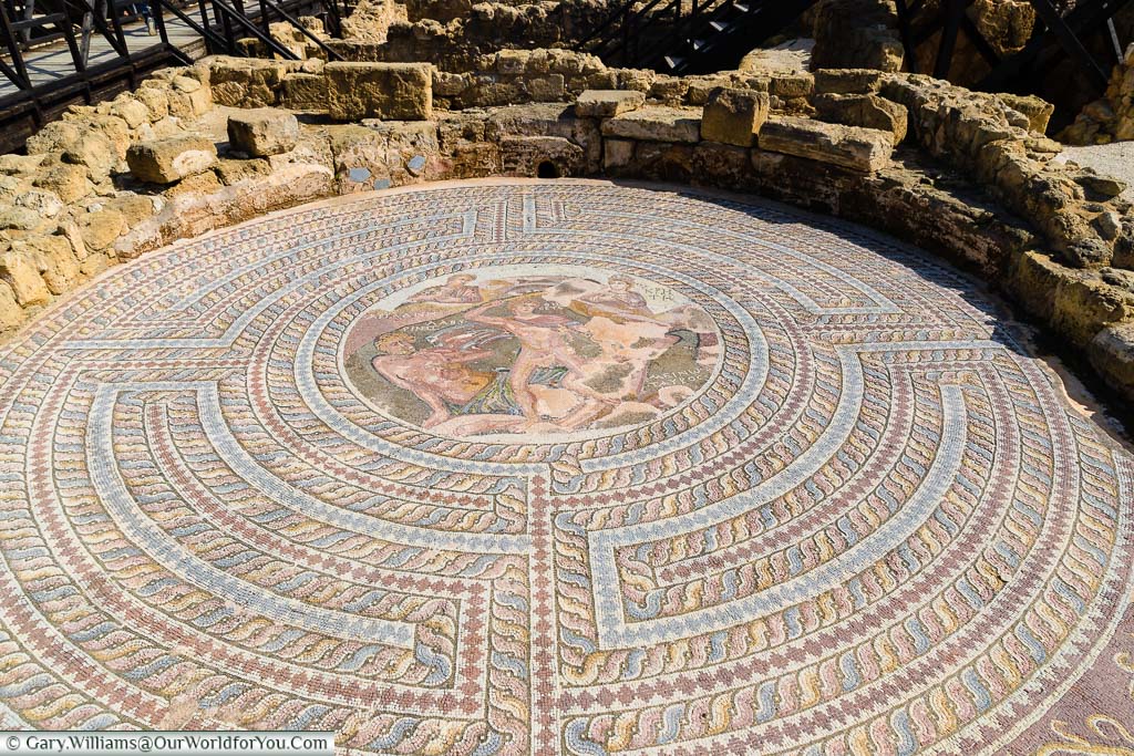 An open-air, colourful circular mosaic in the House of Theseus in the Nea Pafos Archaeological Site