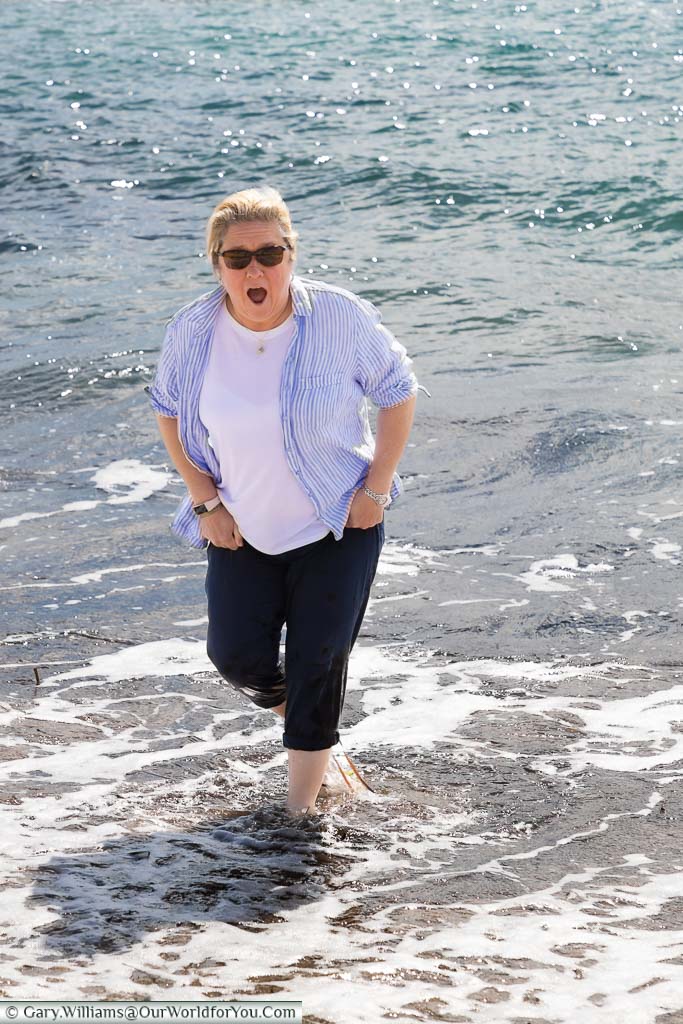 The look of surprise on Janis's face when a slightly larger wave catches her out while dipping her toes in the Mediterranean sea in Paphos, Cyprus