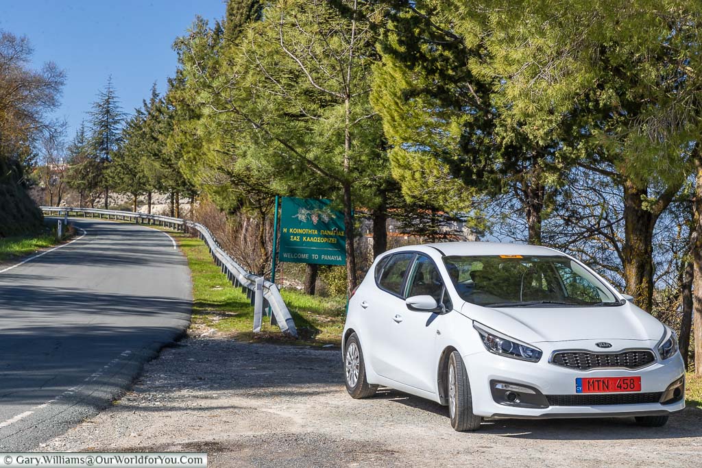 Our white Kia Cee'd hire care parked next to the roadside in the mountains of Cyprus