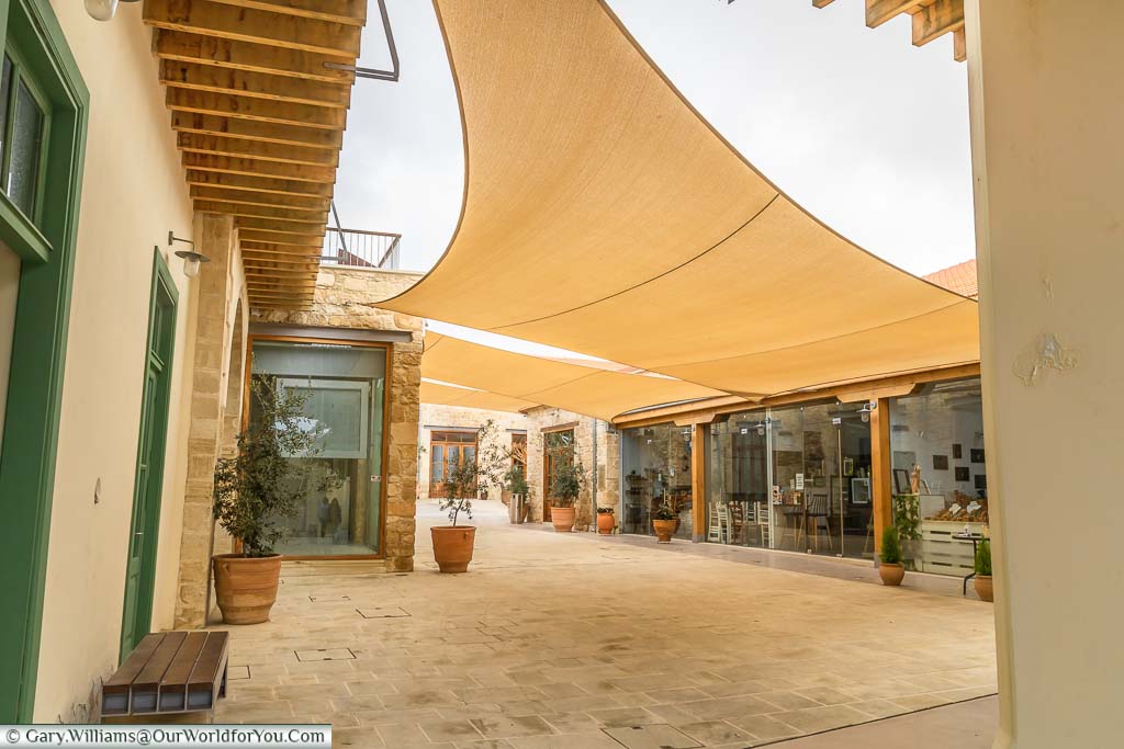A restored courtyard, shielded by canvas sun blinds in Old Town Paphos