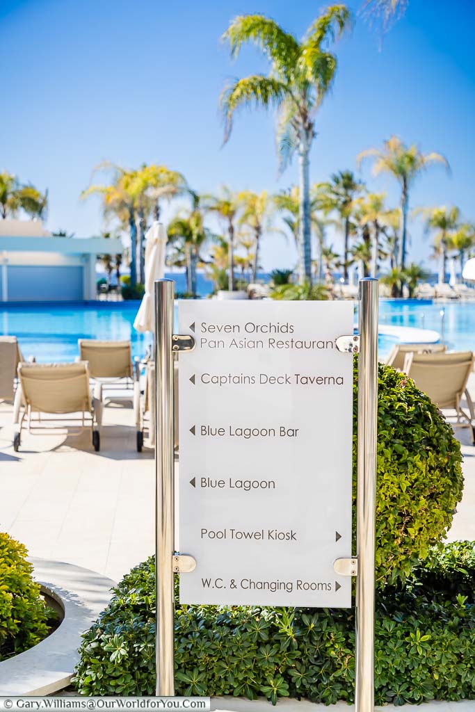 A stylish direction board at the poolside of the Olympic Lagoon Resort Paphos