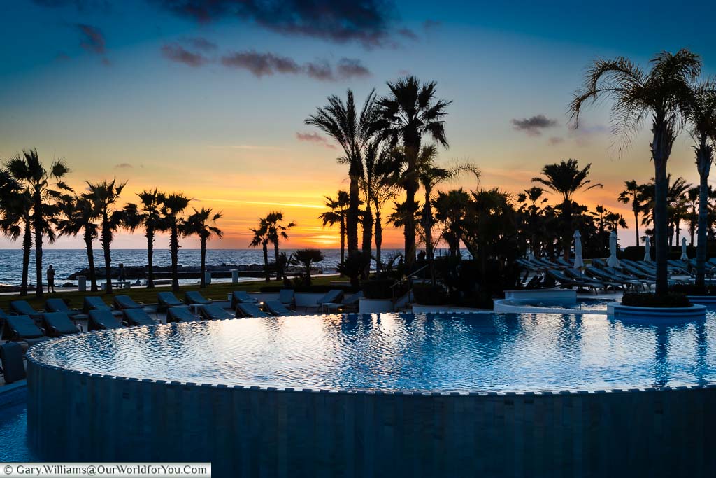 Sunset over the infinity pool at the Olympic Lagoon Resort Paphos
