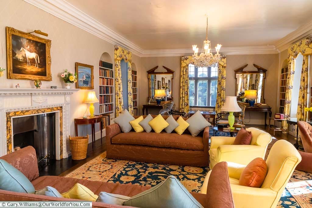 Seating placed in a horseshoe shape around the fire of the Drawing Room of Chartwell House