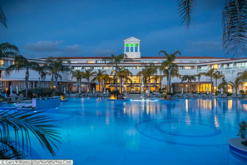The main pool in front of the terrace at the Olympic Lagoon Resort Paphos as the sun goes down.