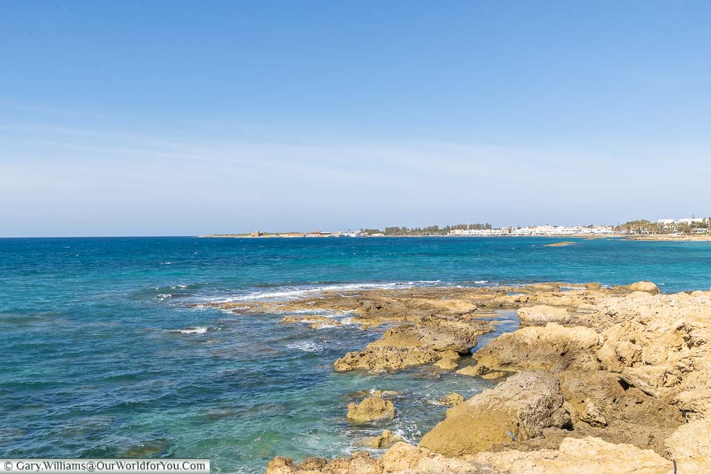 The clear blue waters of the Mediterranean sea from the coastal path outside the Olympic Lagoon Resort Paphos looking towards Paphos Harbour in Cyprus