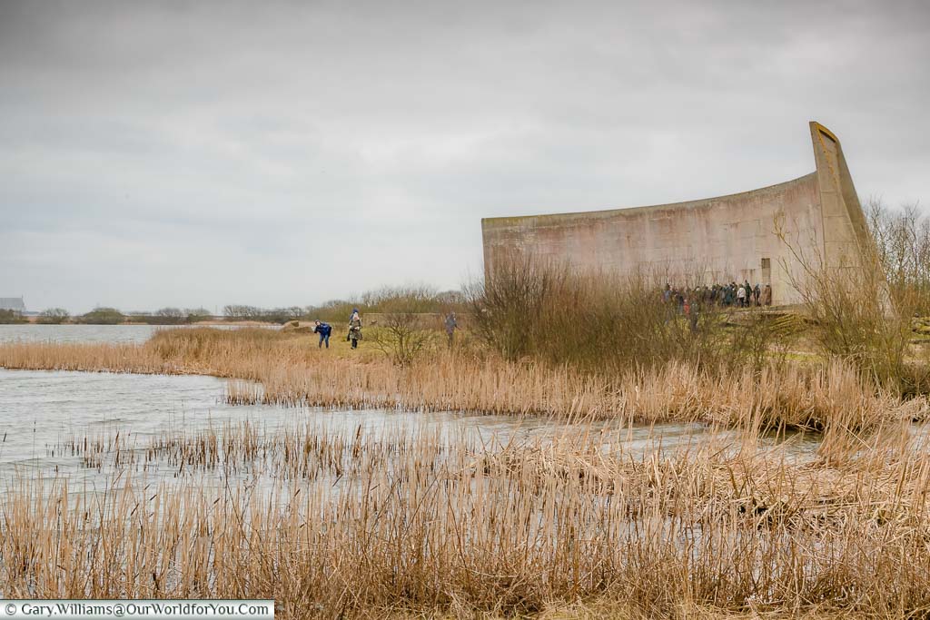 Looking across the reeds to the large concrete sound mirror on Romney Marsh