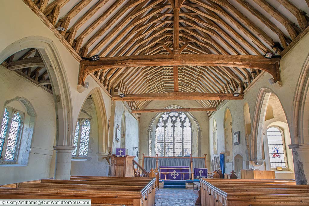 Inside St Mary The Virgin Church on the Romney Marshes with its The medieval wooden vaulted roof and wooden pews