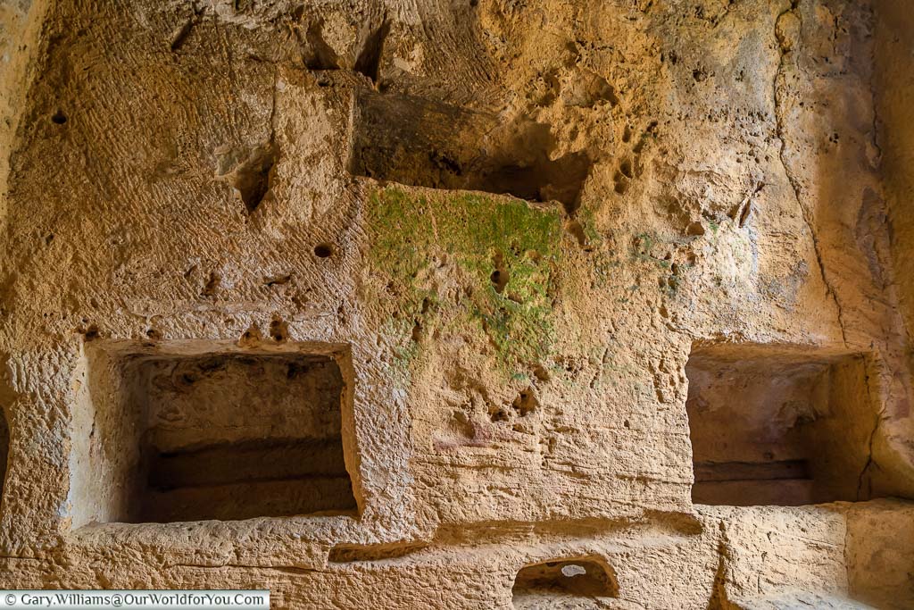 Rectangular burial chambers carved in the stone of the first catacomb in the Tombs of the Kings in Paphos, Cyprus