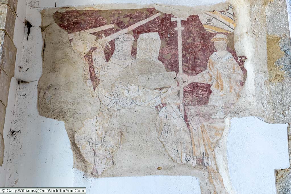 A medieval wall painting depicting the murder of Thomas Becket inside the Church of St Augustine in the village of Brookland on the Romney Marsh in Kent