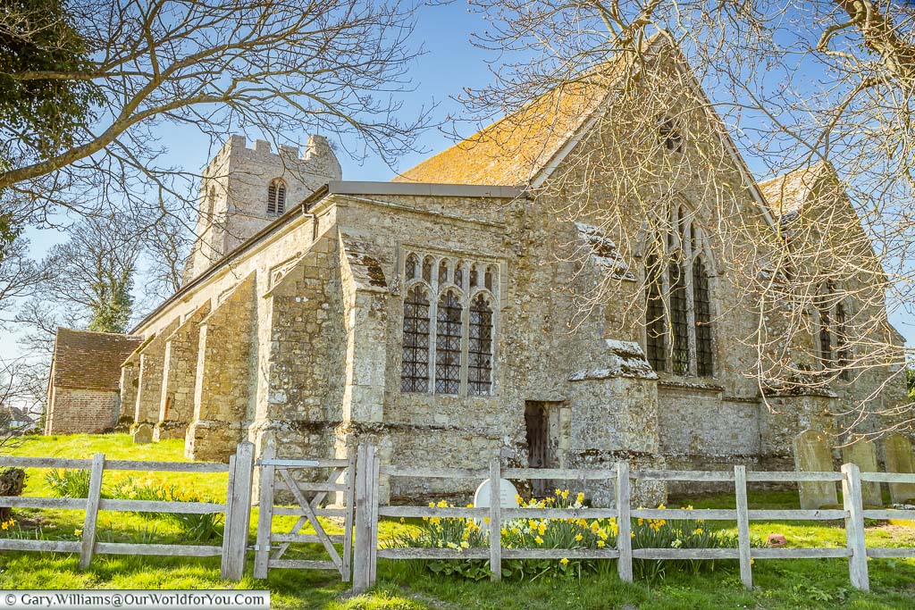 Daffodils in bloom in front of St Dunstan's Church in the village of Snargate on the Romney Marsh in Kent
