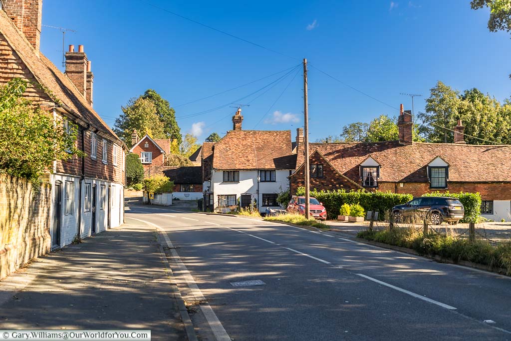The A25 road weaving its way past historic red tiled buildings on the edge of Westerham in Kent