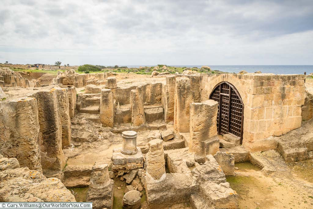 The ruins of Tomb 6 with its sunken stone columns in the Tombs of the Kings in Paphos, Cyprus