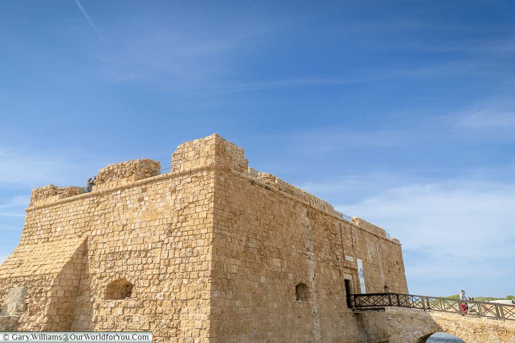 The sandy coloured 16th-century stone Pathos Castle under a blue sky