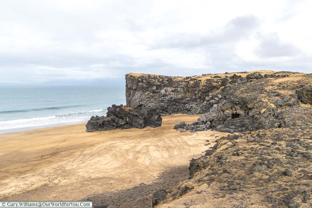 The golden yellow sands of Skarðsvík Beach nestle between basalt rocks in Iceland's north west peninsula.