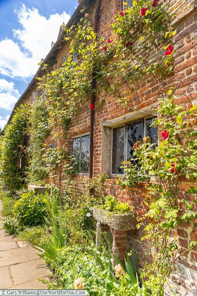 Trained planting all over the walls of the red brick historic Sissinghurst Castle