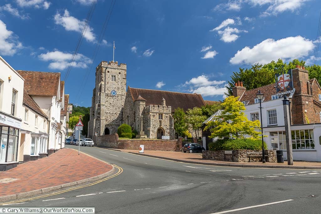 The junction of Bull Lane and the High Street in Wrotham with its village sign and the 14th-century St Georges Church taking centre stage.