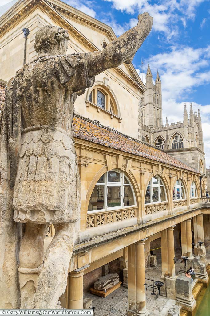 A Victorian statue of Constantine the Great on the upper Terrace overlooking The Roman Bath complex and Bath Abbey in the background
