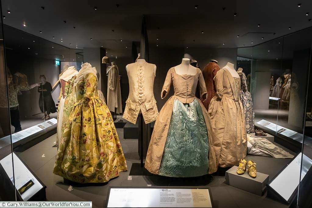 A collection of period costumes on show inside the Fashion Museum in Bath
