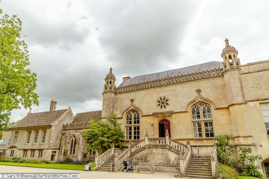 The exterior with its grand staircase leading to the entrance to Lacock Abbey in Wiltshire