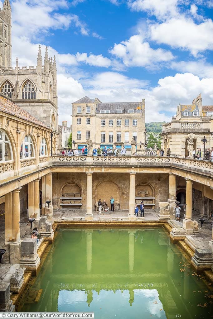 Overlooking the Great Bath of the Roman Baths in Bath from the Victorian upper terrace of the Roman Baths in Bath with the edge of Bath Abbey in shot