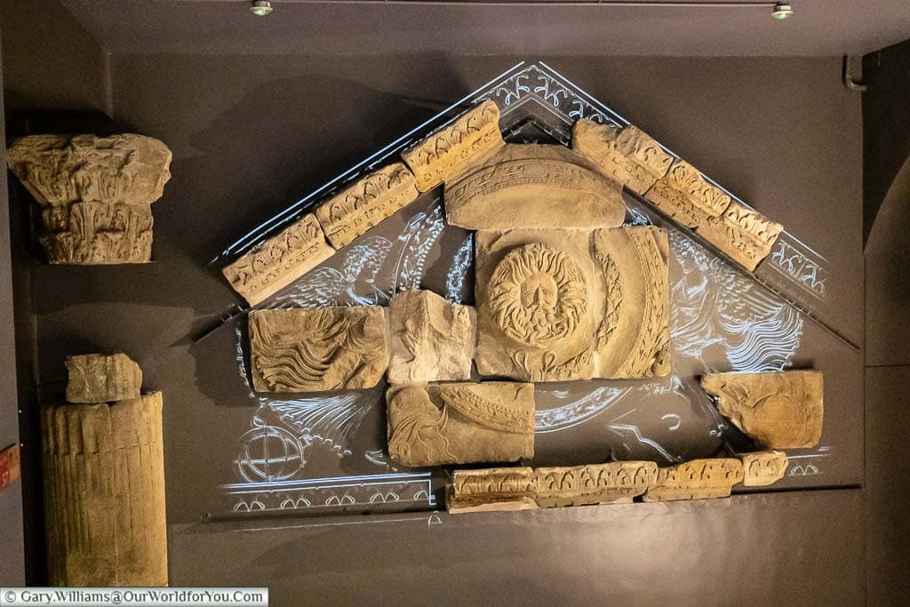 A projection over large fragments of the Temple Pediment in the Bath's museum showing how the entrance to the Roman temple may have looked in Roman times.