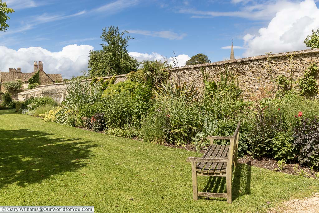 A garden bench in the corner of the walled garden at Lacock Abbey