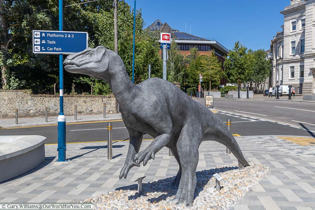 A life-size statue of an Iguanodon outside maidstone east railway station